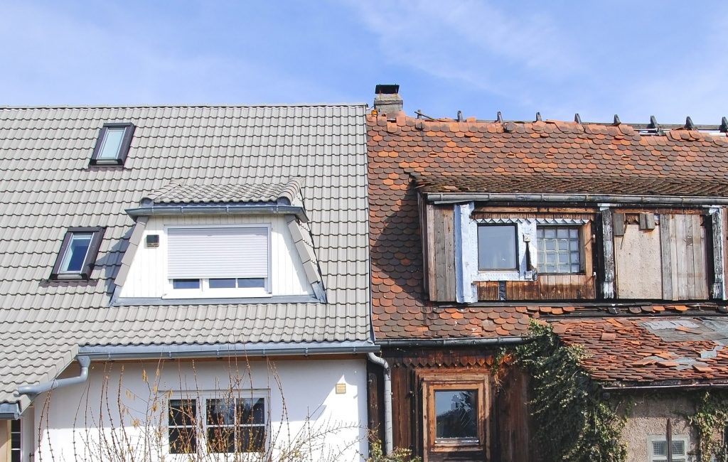 new house next to run-doen old house